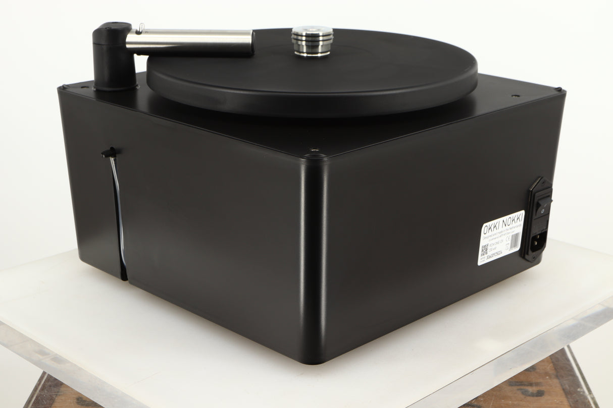 Rear right corner of a used Okki Nokki One Record Cleaning Machine in a black finish