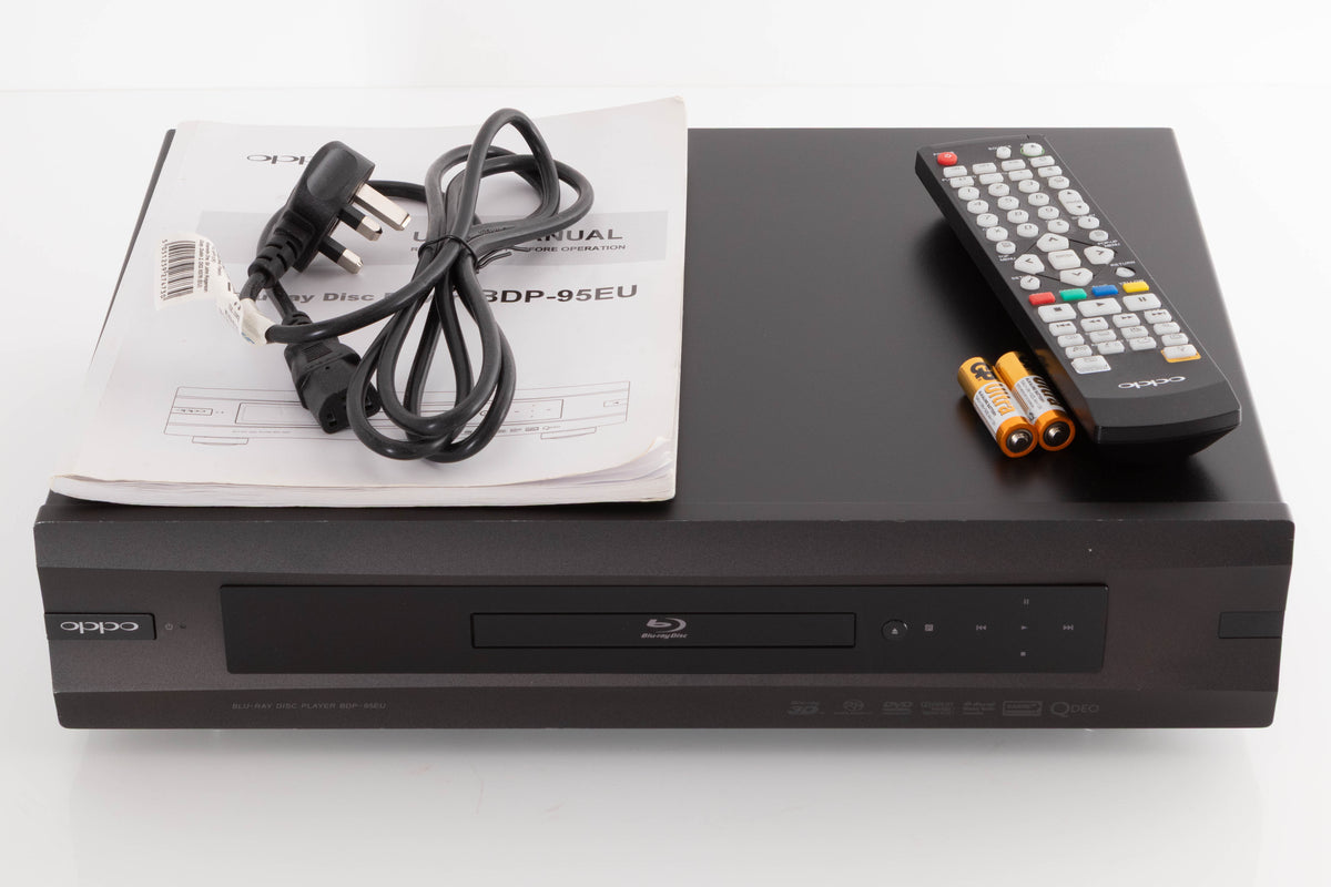 Top of a used Oppo BDP-95EU Blu-Ray Player in a Black finish showing Mains Cable, Manual, Remote and Batteries