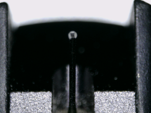 Close up of a used Ortofon Cadenza MC Cartridge in a black finish showing stylus