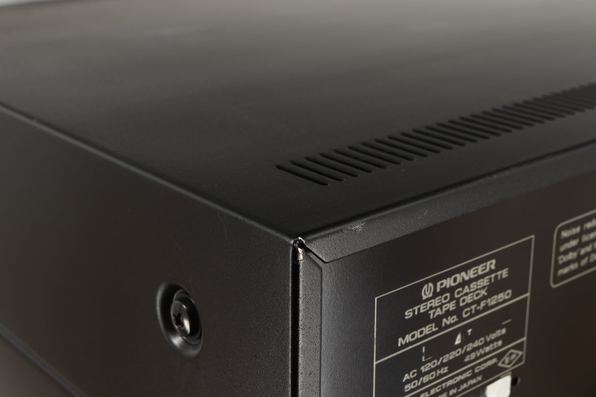 Close up of a used Pioneer CT-F1250 Cassette Deck in a silver finish showing some light scratches