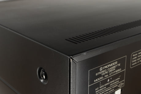 Close up of a used Pioneer CT-F1250 Cassette Deck in a silver finish showing some light scratches