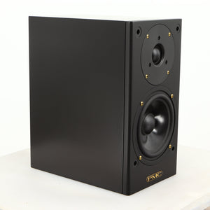 Front left corner of a used PMC DB1 Gold Standmount Speaker in a black finish showing some scratching