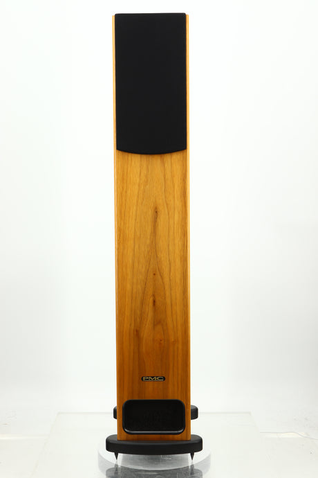 Front view of a PMC GB1 Floorstanding Speaker in a oak finish showing a grille
