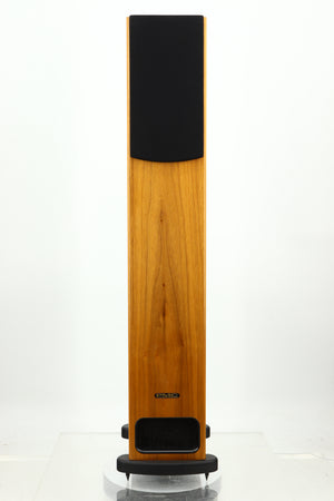 Front view of a PMC GB1 Floorstanding Speaker in a oak finish showing a grille