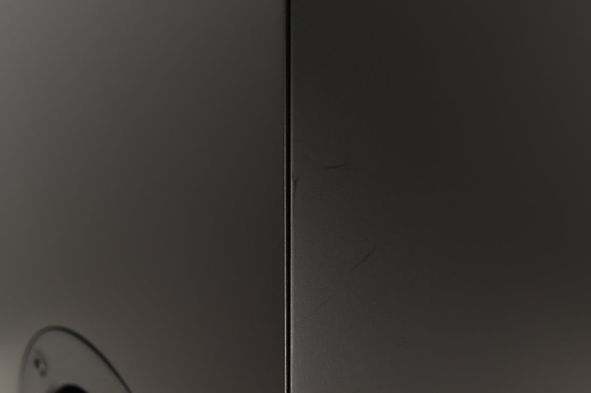 Close up of a used PMC Prodigy 1 Standmount Speakers in a black finish showing some scratching