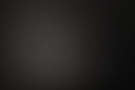 Close up of a used PMC Prodigy 1 Standmount Speaker in a black finish showing light scratch on right side 