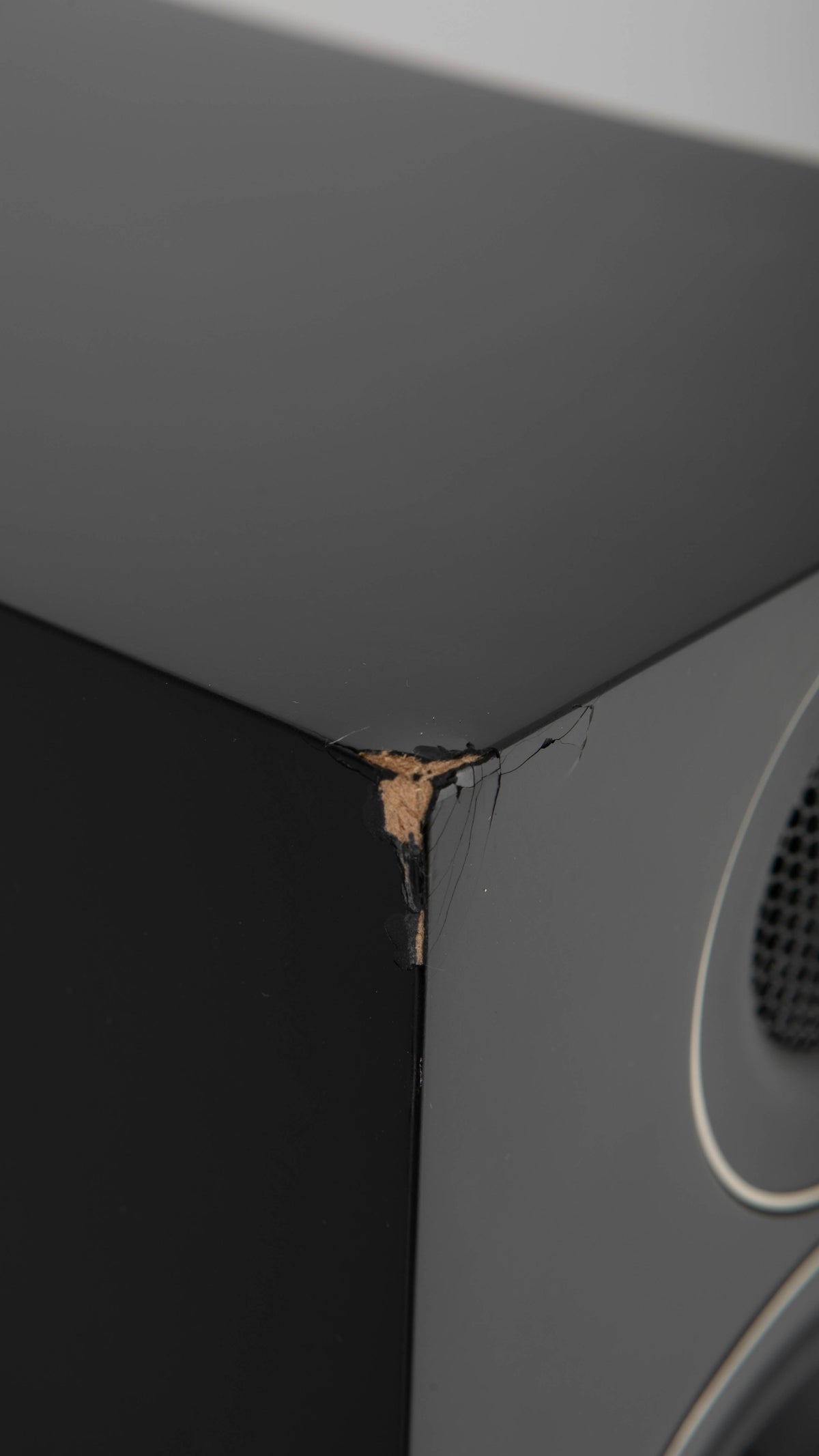 Close up of a used PMC Prodigy5 Floorstanding Speaker in a Black finish showing crack on front left corner