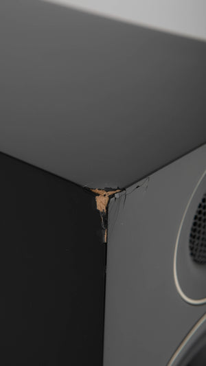 Close up of a used PMC Prodigy5 Floorstanding Speaker in a Black finish showing crack on front left corner