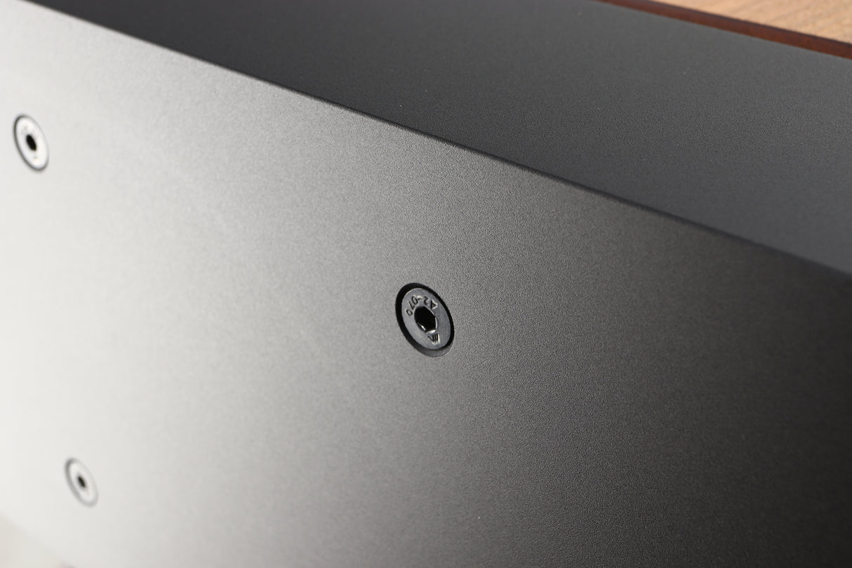Close up of a used PMC ProphecyC Centre Speaker in a walnut finish showing a light scratch on right side