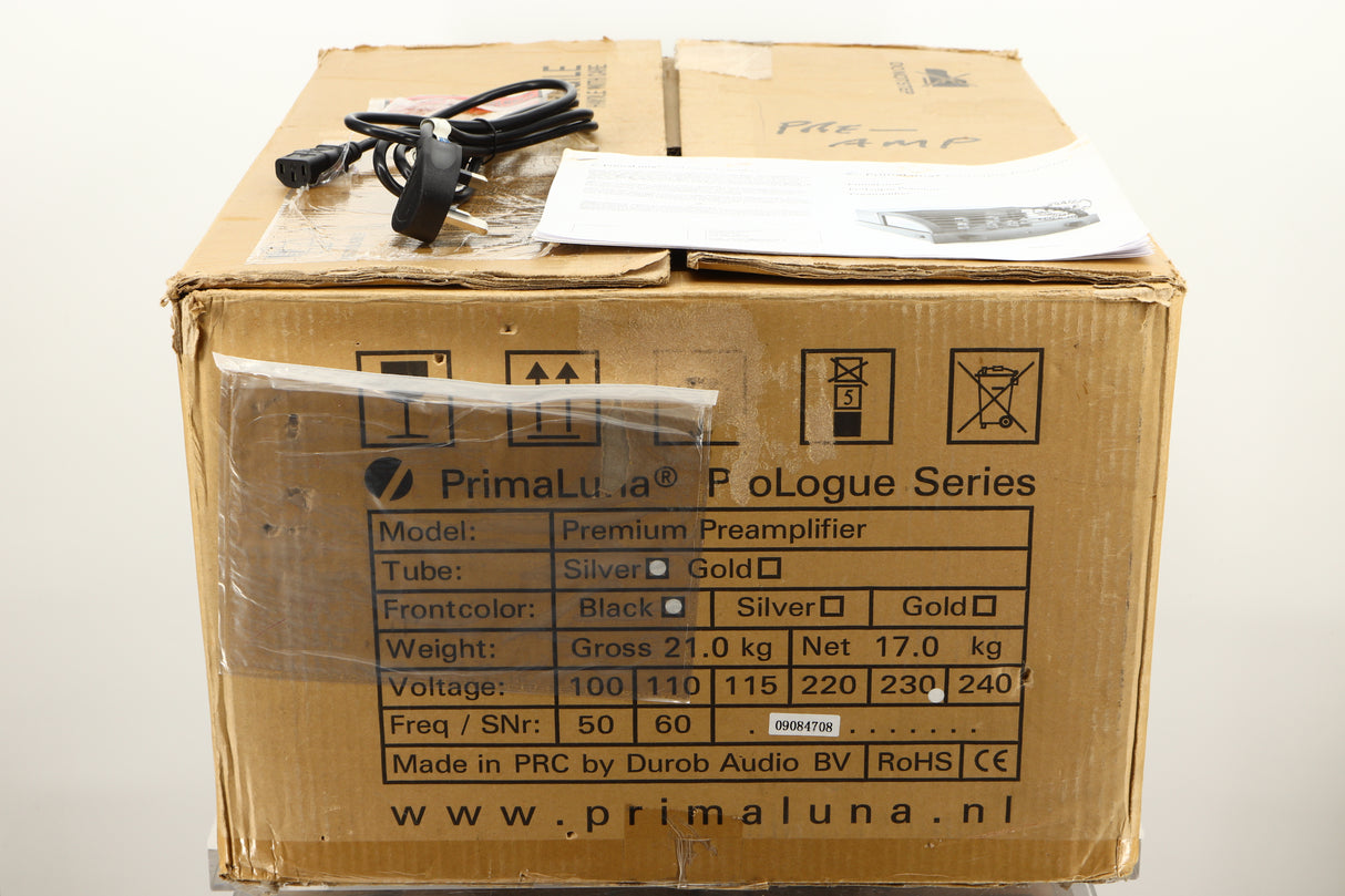 Box of a used PrimaLuna Prologue Premium Pre Amplifier in Black finish showing mains cable, and manual