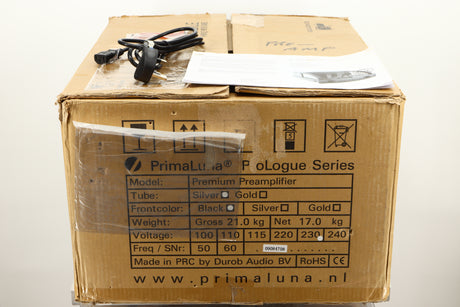 Box of a used PrimaLuna Prologue Premium Pre Amplifier in Black finish showing mains cable, and manual