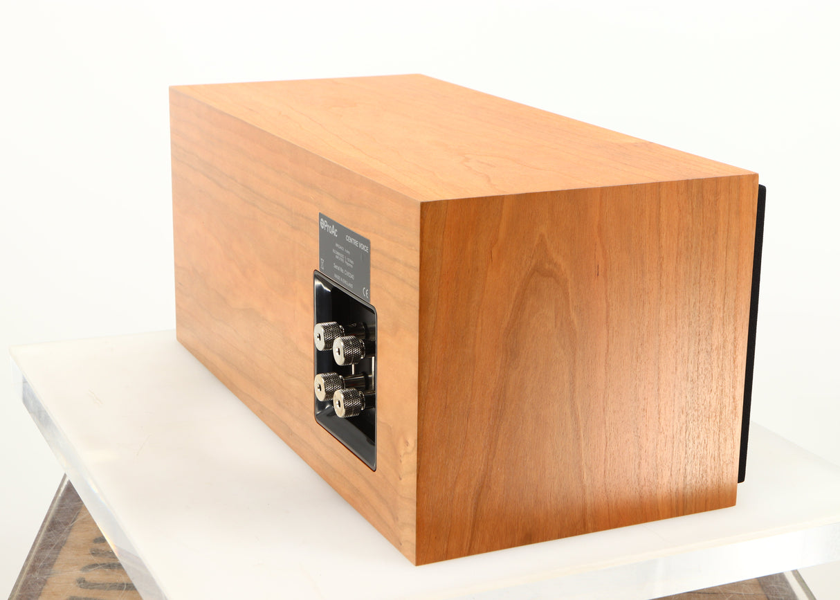 Rear left corner of a used ProAc Centre Voice Speaker in a cherry finish