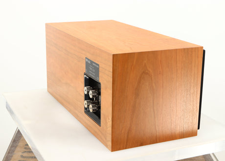 Rear left corner of a used ProAc Centre Voice Speaker in a cherry finish