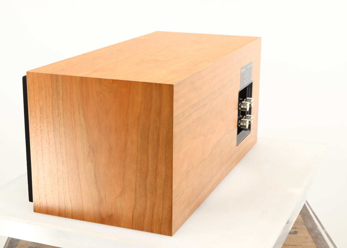 Rear right corner of a used ProAc Centre Voice Speaker in a cherry finish
