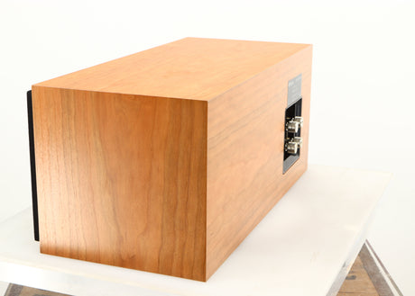 Rear right corner of a used ProAc Centre Voice Speaker in a cherry finish