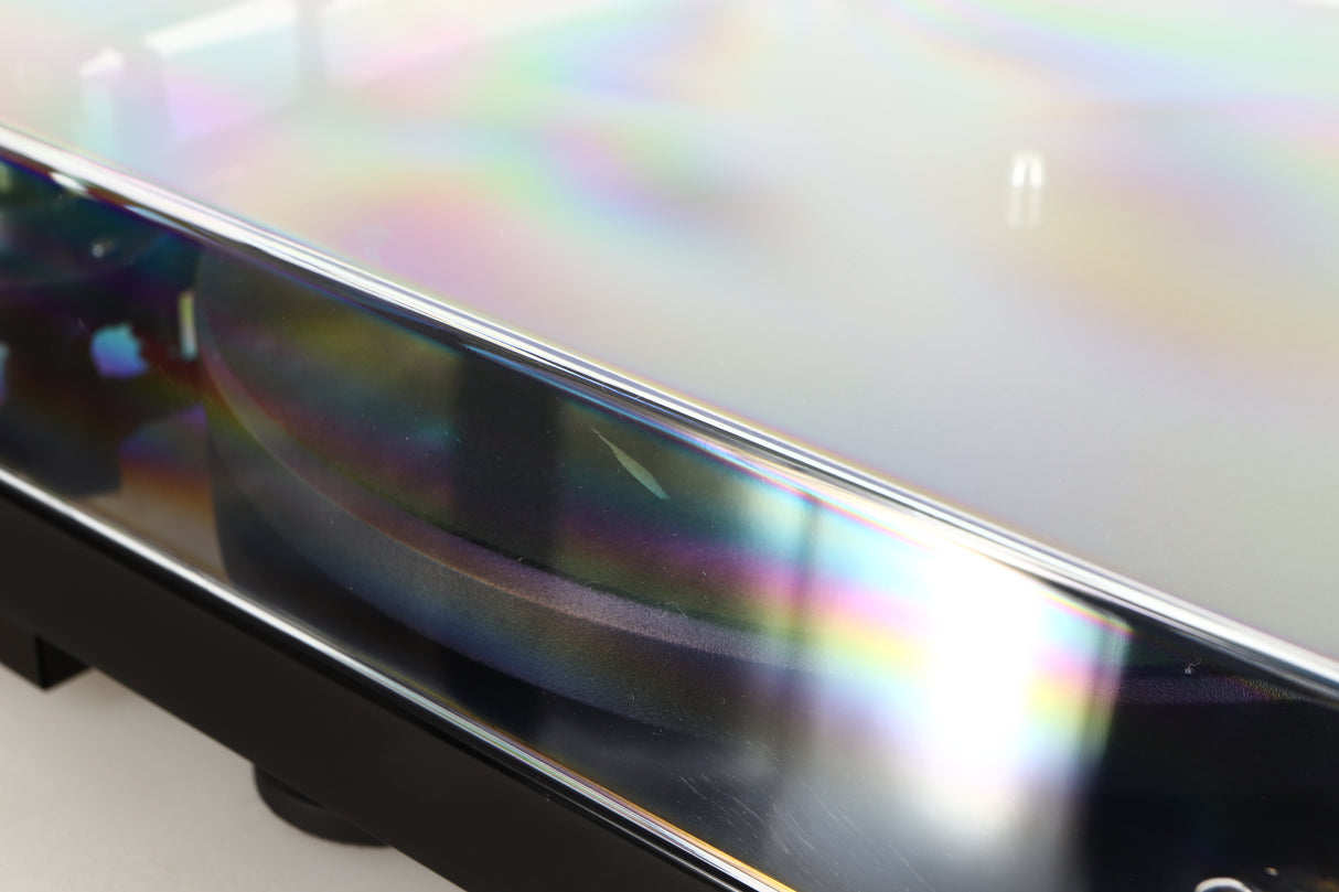 Close up of a used Project Debut Carbon Evo DC Turntable in a black finish showing scratching on lid