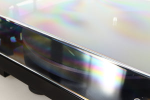 Close up of a used Project Debut Carbon Evo DC Turntable in a black finish showing scratching on lid