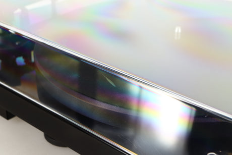 Close up of a used Project Debut Carbon Evo DC Turntable in a black finish showing scratching on lid