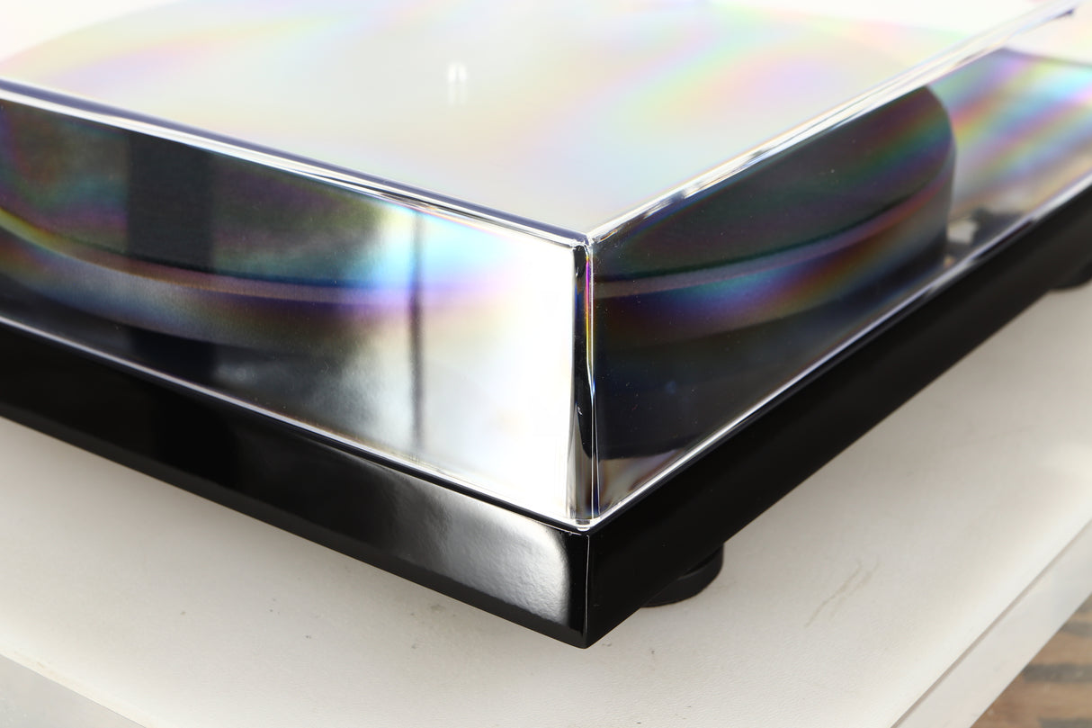 Front left corner of a used Project Debut Carbon Evo DC Turntable in a black finish