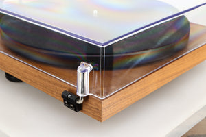 Rear left corner of a used Project Debut Carbon Evo Turntable / Ortofon 2M Bronze Cartridge in a walnut finish