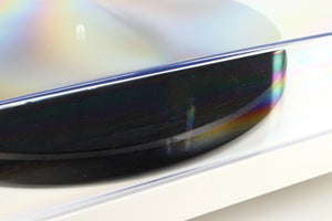 Close up of a used Project Debut Carbon Turntable / Ortofon 2M Blue Cartridge in a white finish showing some scratching on lid
