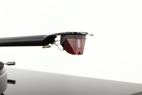 Close up of a used Project Debut Carbon Turntable in a piano black finish showing stylus