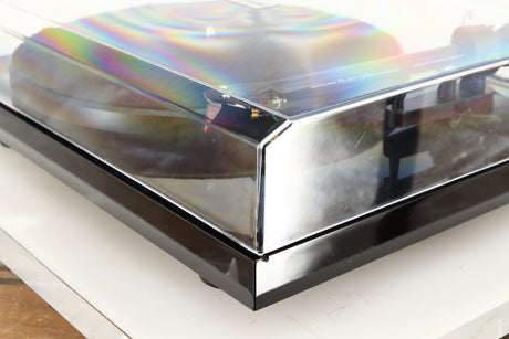Front right corner of a used Project Debut Carbon Turntable in a piano black finish
