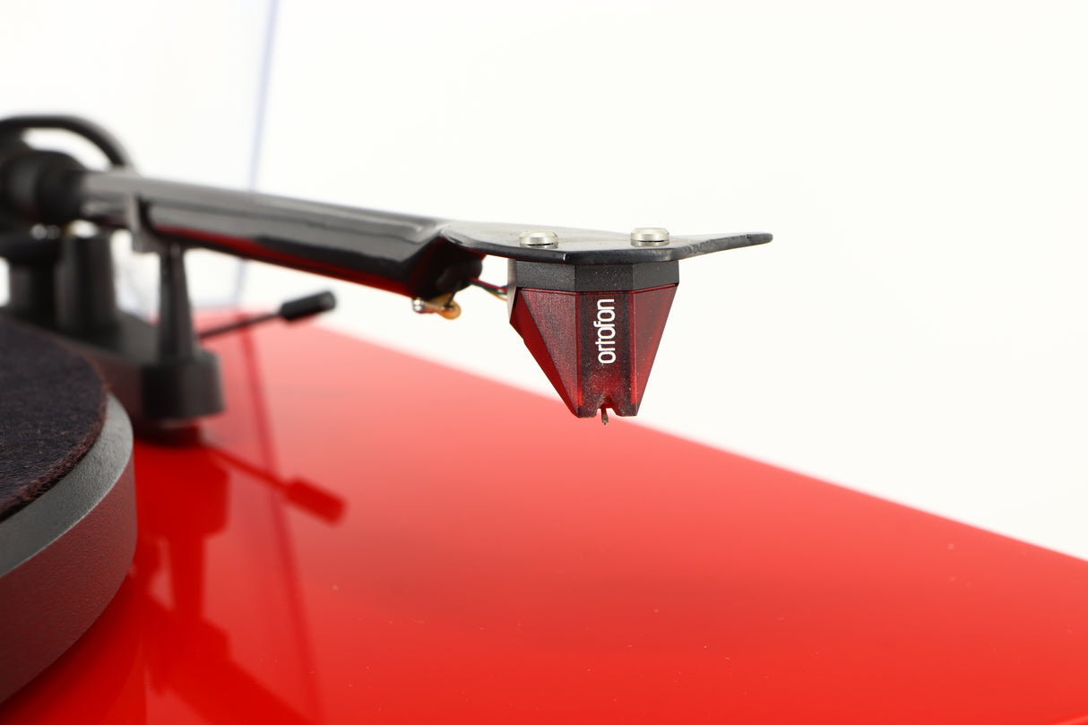 Close up of a used Project Debut Carbon Turntable in a red finish showing stylus