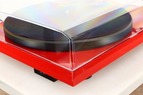 Front left corner of a used Project Debut Carbon Turntable in a red finish