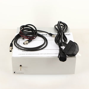 Top of a used Project Power Box RS Uni-1-Way Power Supply in a silver finish showing Mains Cable, Manual and Project Connect It Power Cable