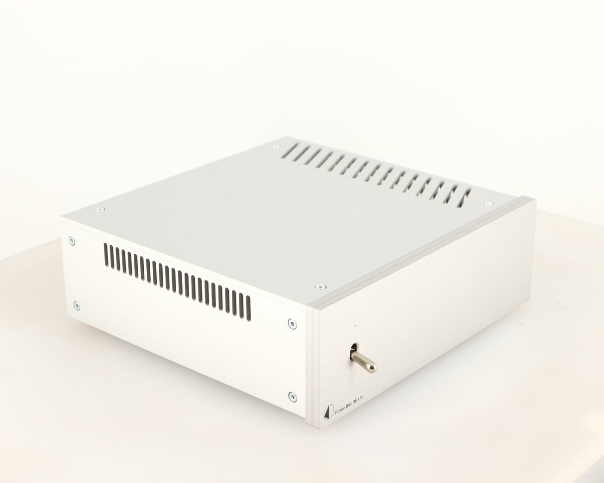 Front left corner of a used Project Power Box RS Uni-1-Way Power Supply in a silver finish