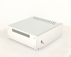 Front left corner of a used Project Power Box RS Uni-1-Way Power Supply in a silver finish
