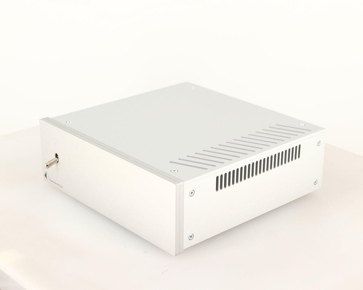 Front right corner of a used Project Power Box RS Uni-1-Way Power Supply in a silver finish