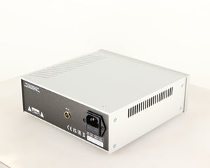Rear left corner of a used Project Power Box RS Uni-1-Way Power Supply in a silver finish