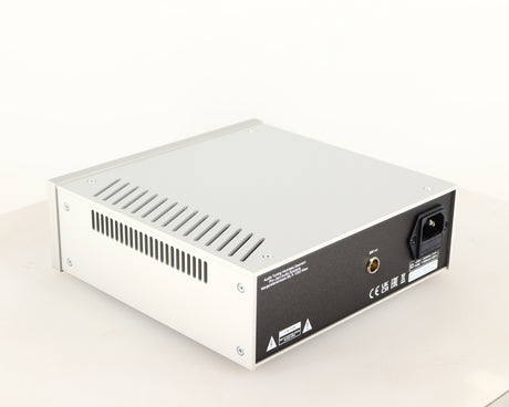 Rear right corner of a used Project Power Box RS Uni-1-Way Power Supply in a silver finish