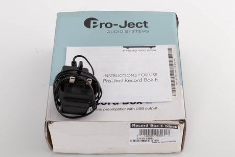 Box for a used Project Record Box E Phonostage in a Black finish showing PSU and Manual