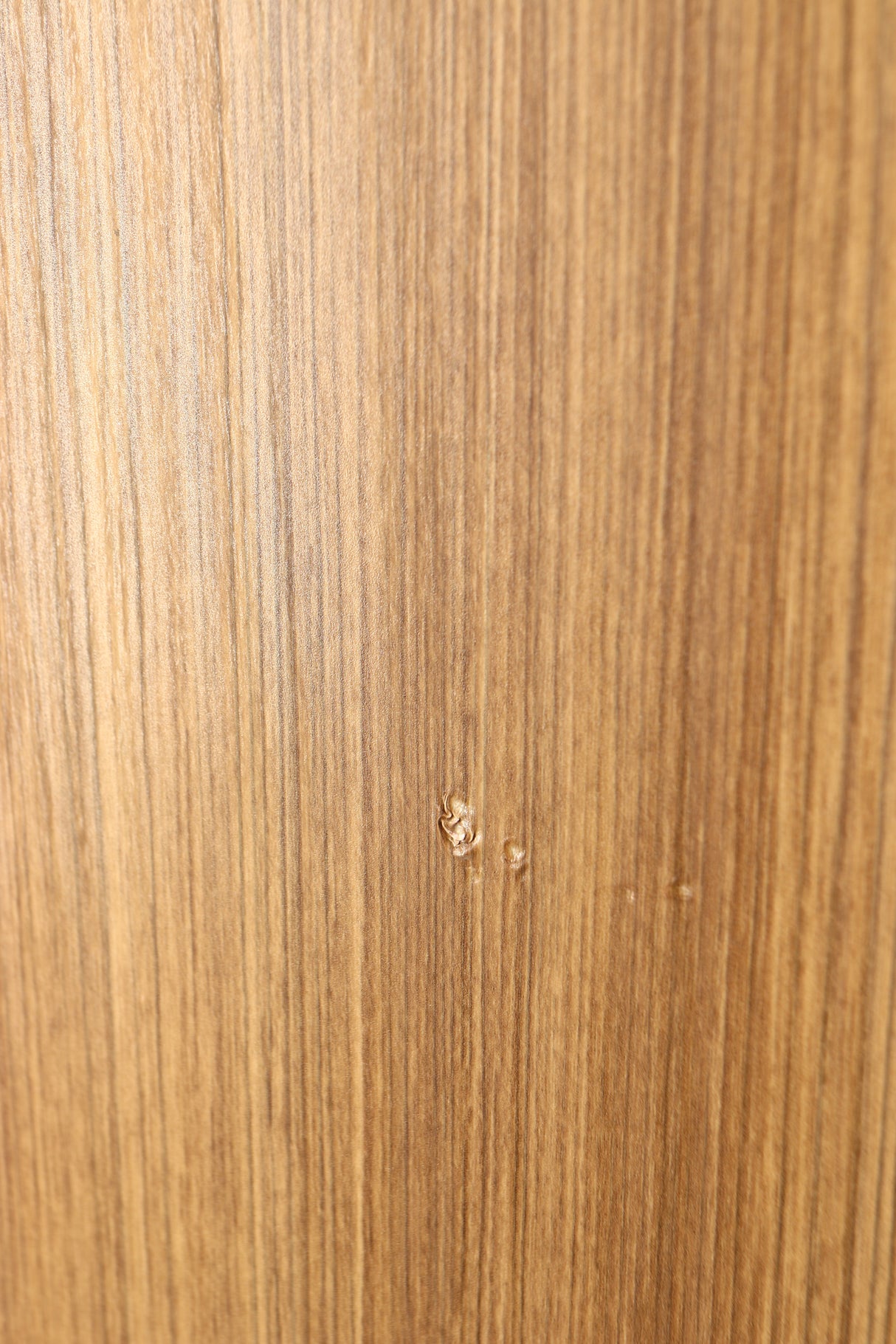Close up of a used Q Acoustics 5050 Floorstanding Speaker in an oak finish showing some damage on cabinet