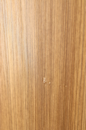Close up of a used Q Acoustics 5050 Floorstanding Speaker in an oak finish showing some damage on cabinet