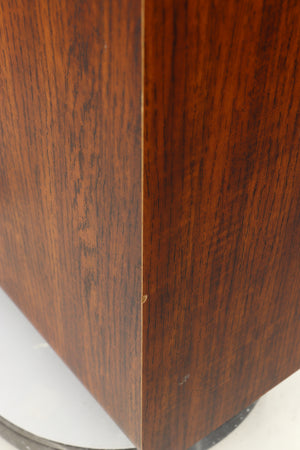 Close up of a used Q Acoustics 3050i Floorstanding Speakers in a walnut finish showing chip on front left corner