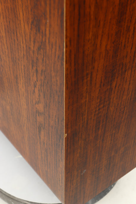 Close up of a used Q Acoustics 3050i Floorstanding Speakers in a walnut finish showing chip on front left corner