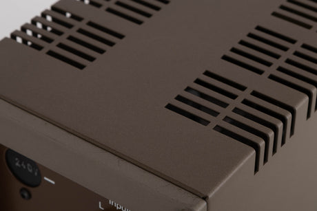 Close up of a used Quad 303 Power Amplifier showing scratching on rear edge