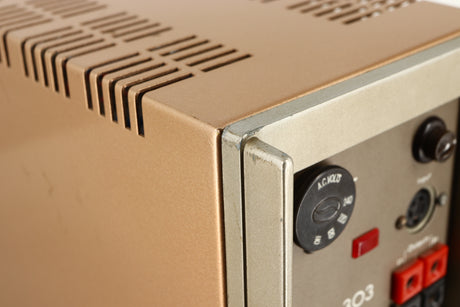 Close up of a used Quad 303 Power Amplifier showing some damage on rear right corner