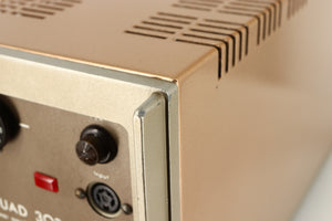 Close up of a used Quad 303 Power Amplifier showing some damage on rear left corner