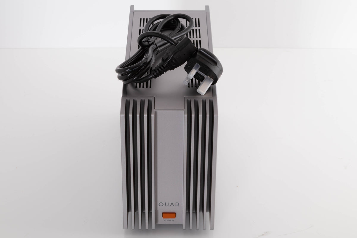 Top of a used Quad 303 Power Amplifier in a Silver finish showing Mains Cable