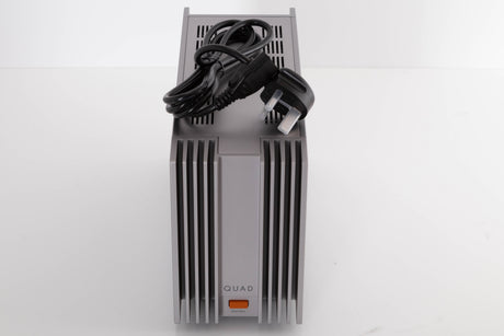 Top of a used Quad 303 Power Amplifier in a Silver finish showing Mains Cable