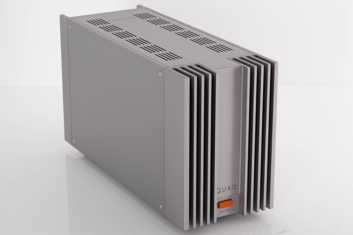 Front left corner of a used Quad 303 Power Amplifier in a Silver finish