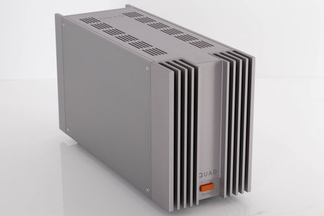Front left corner of a used Quad 303 Power Amplifier in a Silver finish