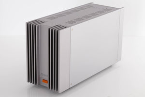 Front right corner of a used Quad 303 Power Amplifier in a Silver finish