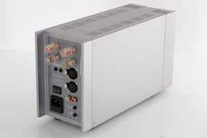 Rear left corner of a used Quad 303 Power Amplifier in a Silver finish