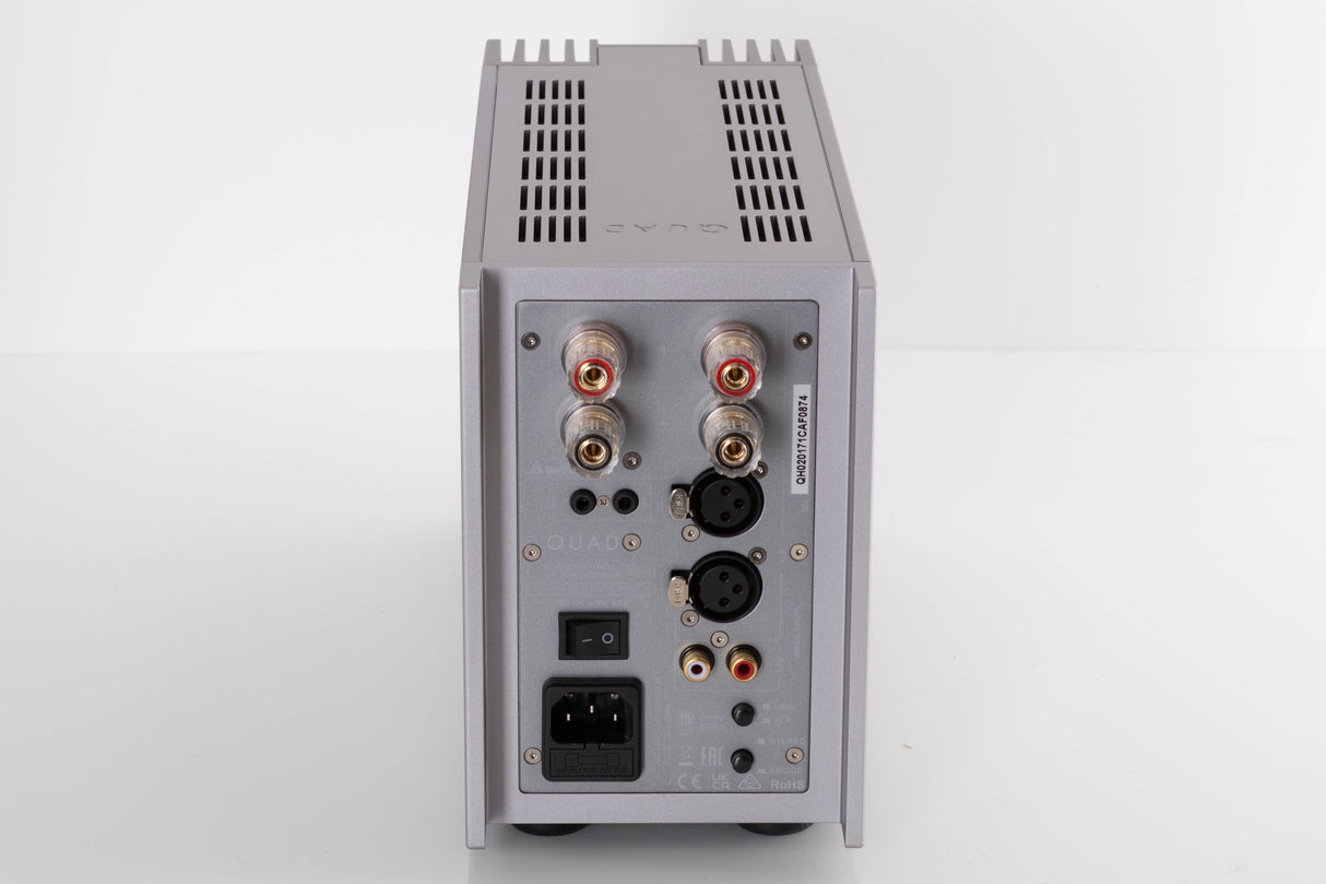 Rear view of a used Quad 303 Power Amplifier in a Silver finish showing Mains Input, Phono Inputs, XLR Inputs and Speaker Inputs